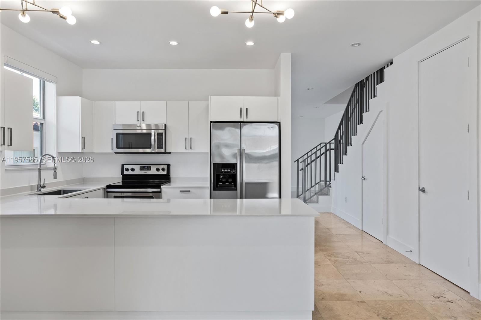 2784 Southwest 34th Avenue Miami, FL 33133 - Photo 14 of 45 a kitchen with stainless steel appliances a refrigerator and a stove top oven