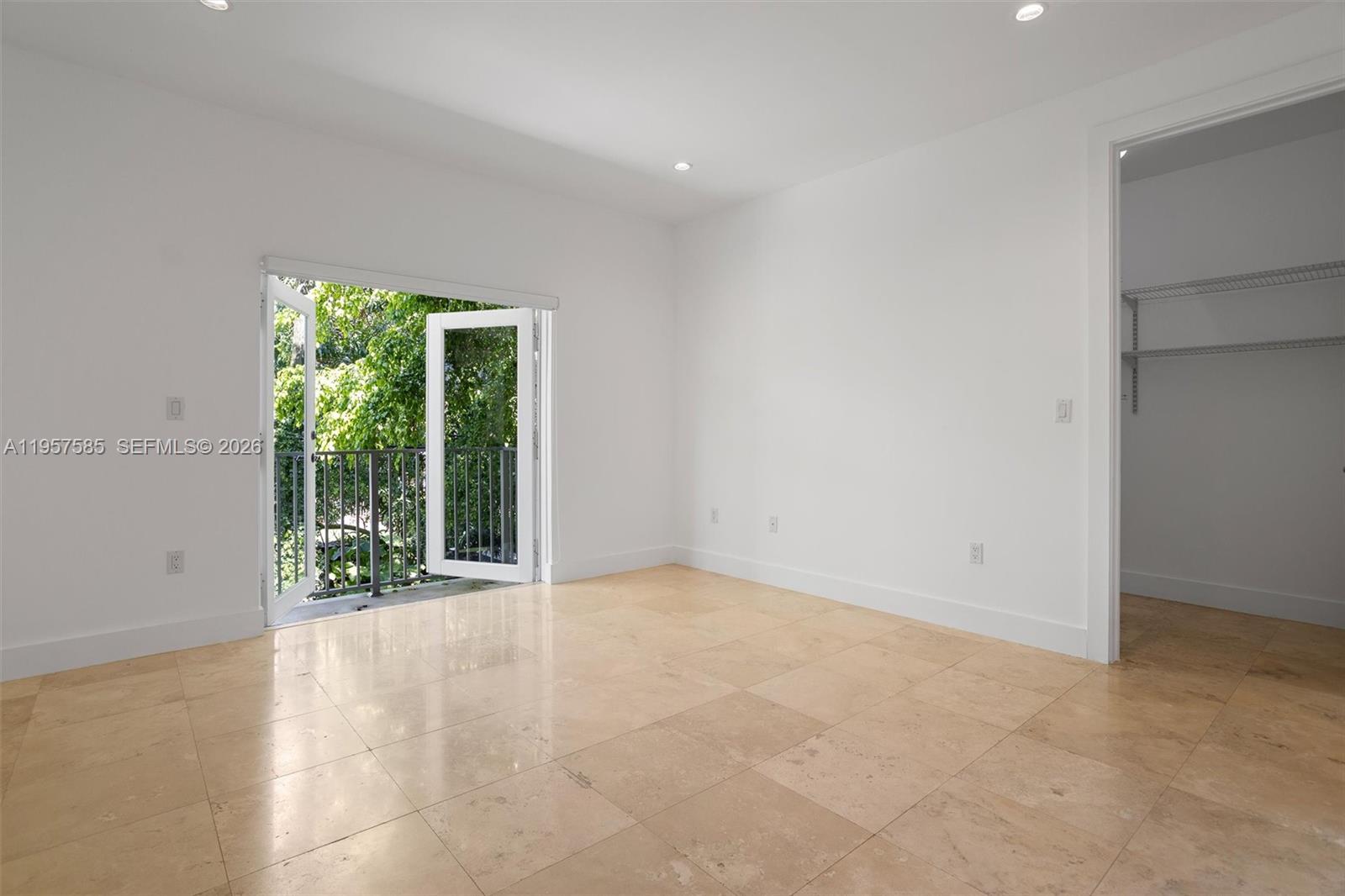 2784 Southwest 34th Avenue Miami, FL 33133 - Photo 19 of 45 a view of an empty room with wooden floor and a window