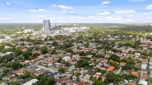 an aerial view of residential building with green space