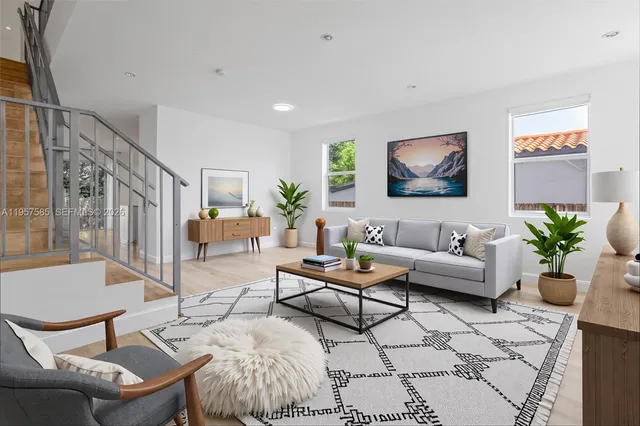 a living room with furniture and wooden floor