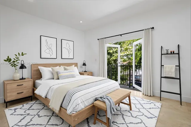 a bedroom with a large bed and a window