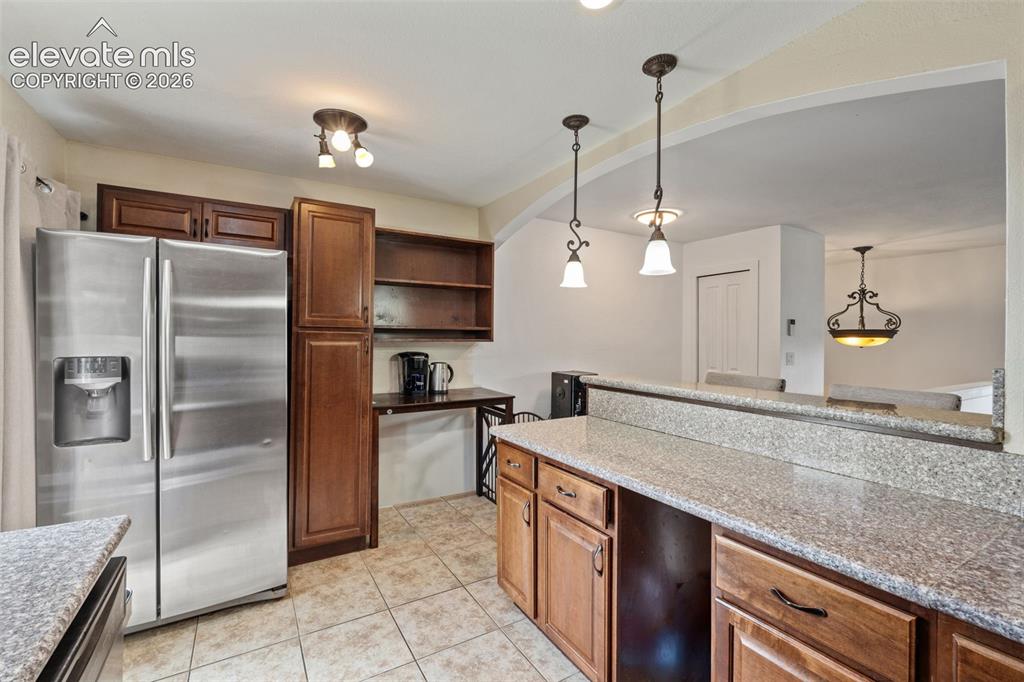 125 Diamond E Road Fountain, CO 80817 - Photo 15 of 43 a kitchen with kitchen island granite countertop a sink and refrigerator