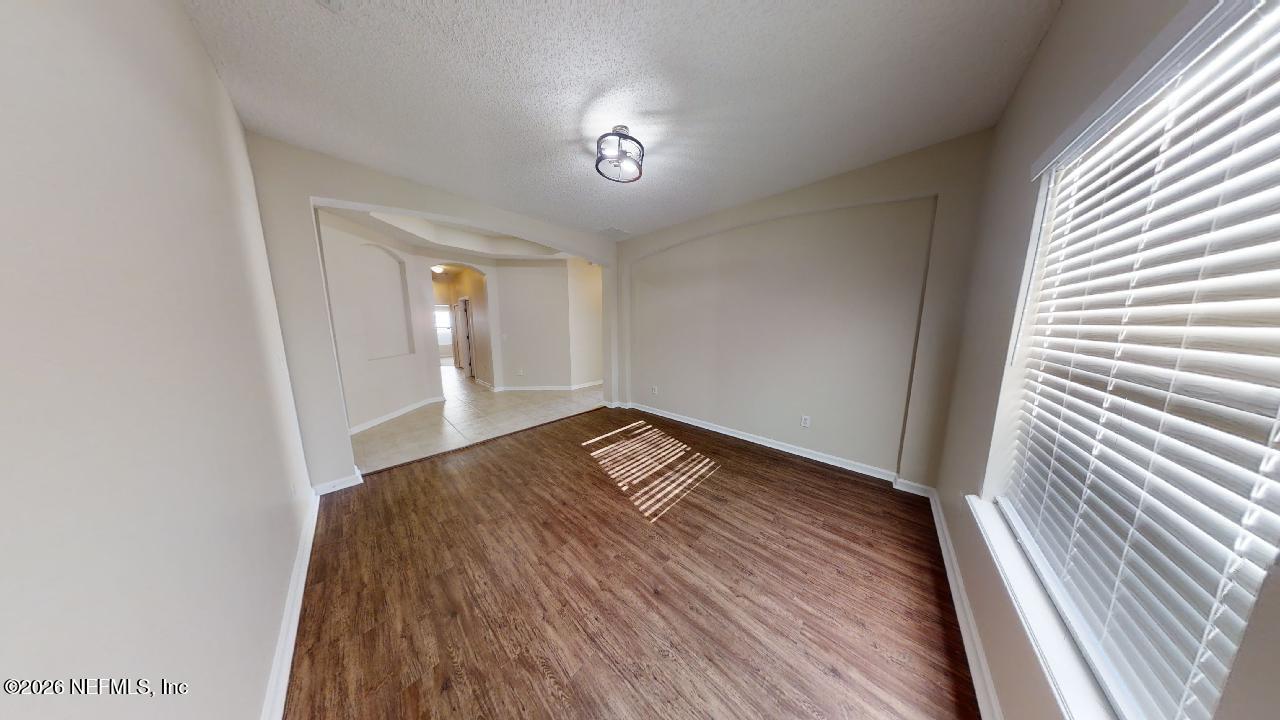 14454 Millhopper Road Jacksonville, FL 32258 - Photo 10 of 44 a view of a room with wooden floor and natural light