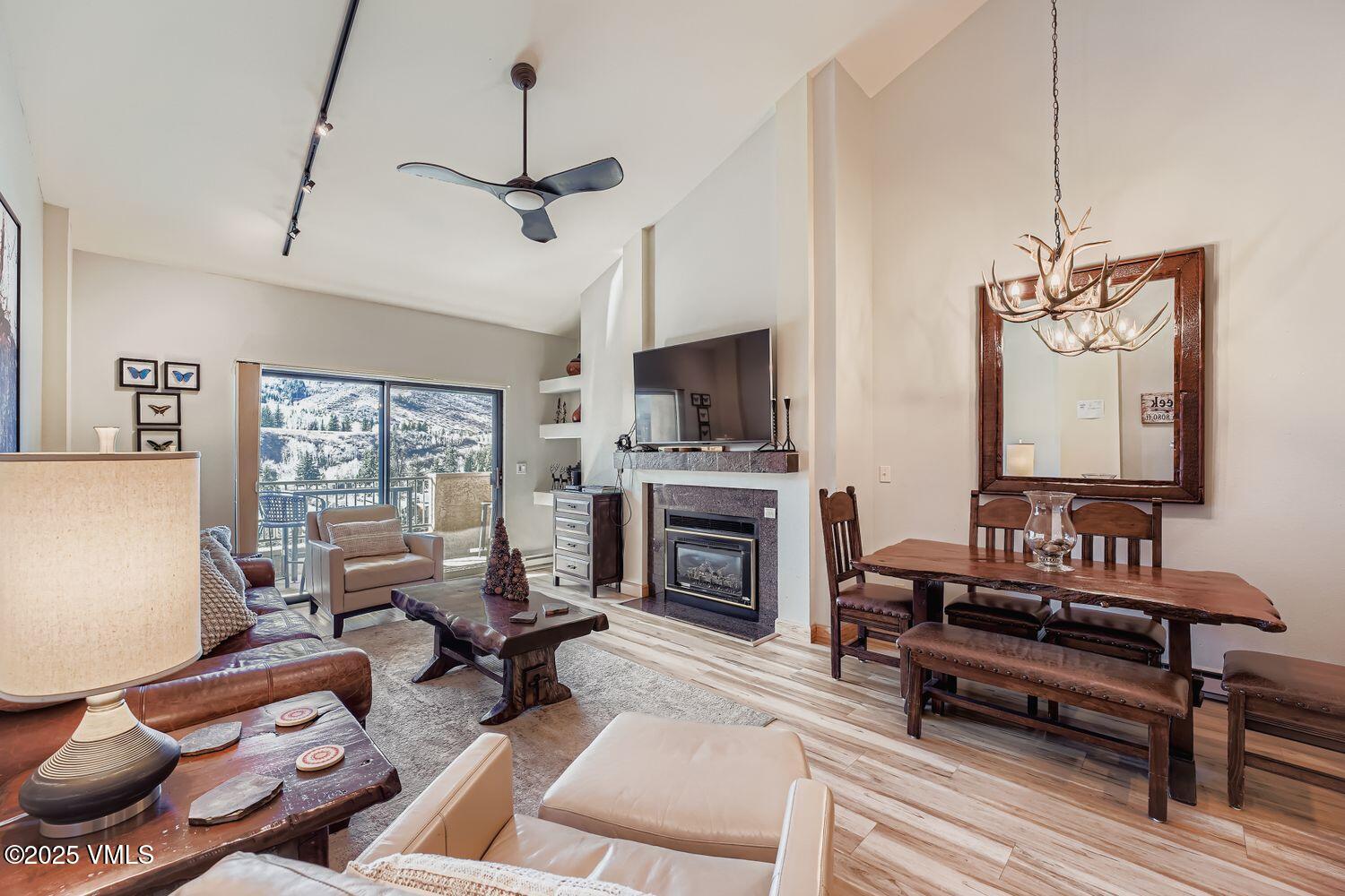 137 Benchmark Road, Unit 520 Avon, CO 81620 - Photo 1 of 26 a living room with furniture a fireplace and a flat screen tv