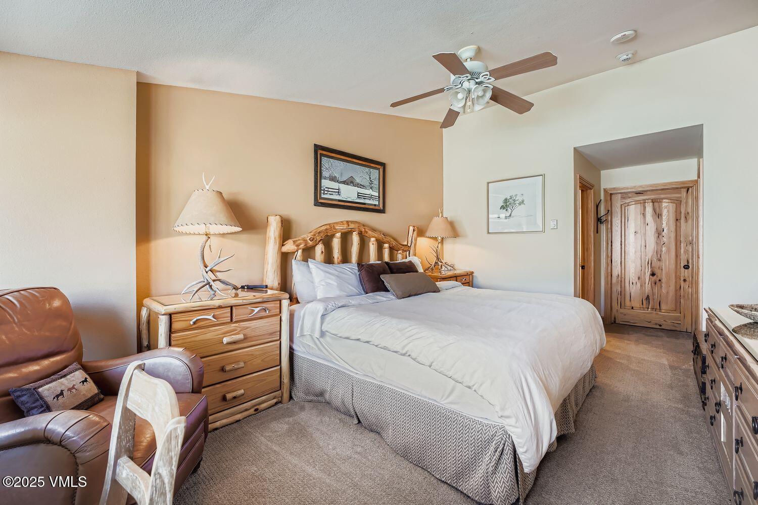 137 Benchmark Road, Unit 520 Avon, CO 81620 - Photo 12 of 26 a bedroom with a bed couch and window