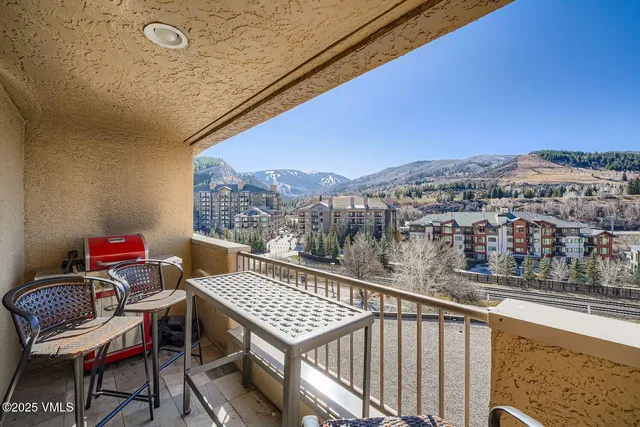 a view of a balcony with a table and chairs