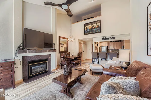 a living room with furniture a fireplace and a flat screen tv