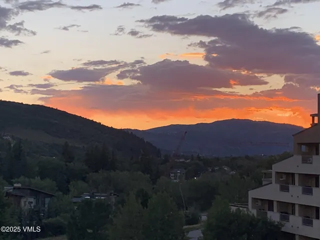a view of a town with mountains in the background