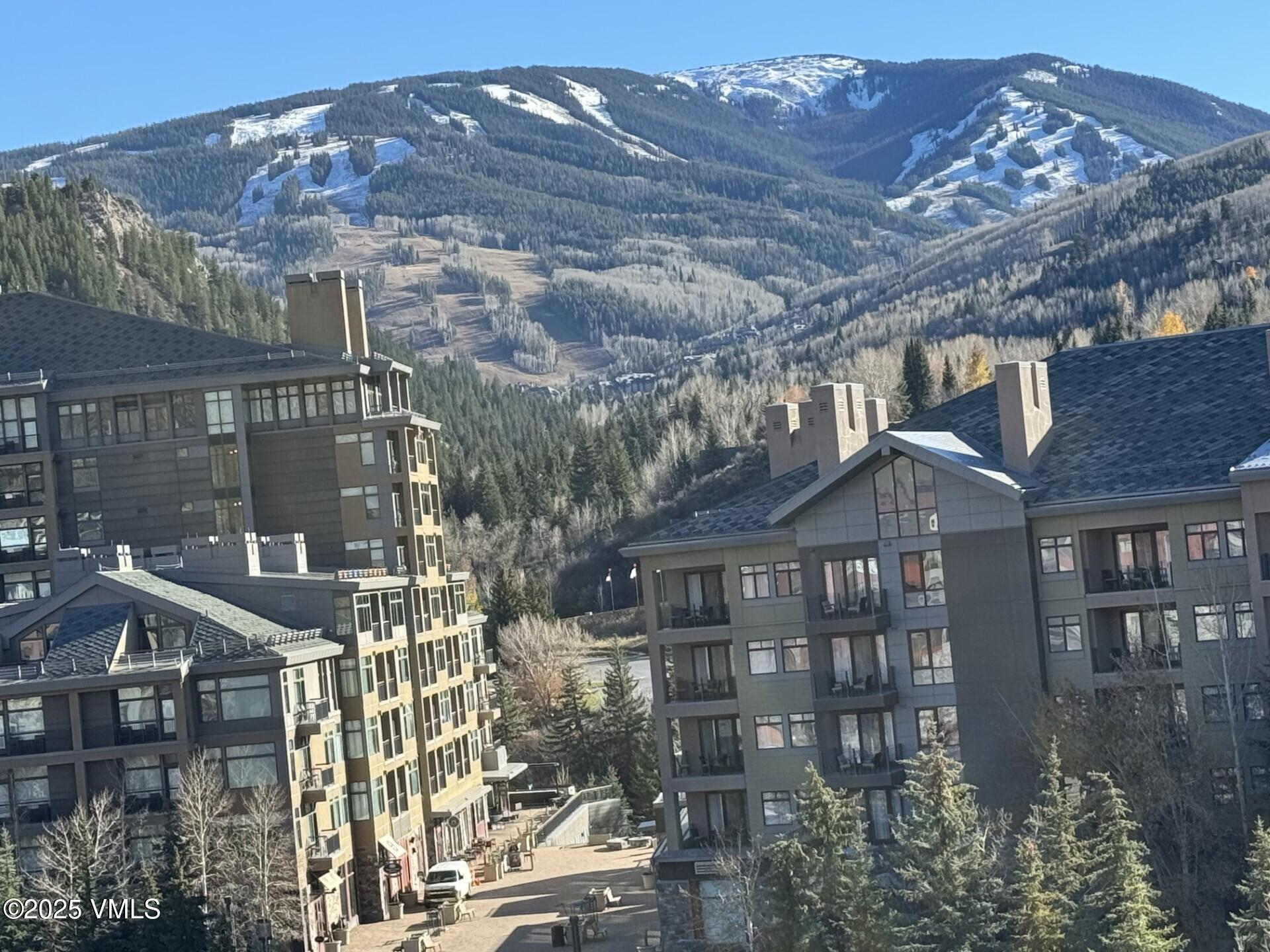 137 Benchmark Road, Unit 520 Avon, CO 81620 - Photo 26 of 26 a front view of a house with a yard and outdoor seating
