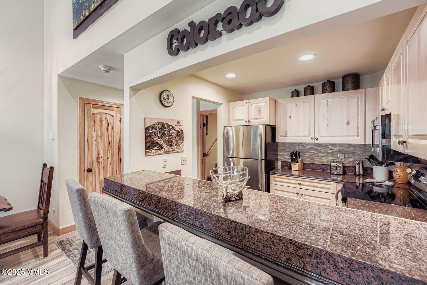 137 Benchmark Road, Unit 520 Avon, CO 81620 - Photo 5 of 26 a kitchen with stainless steel appliances granite countertop a sink and cabinets