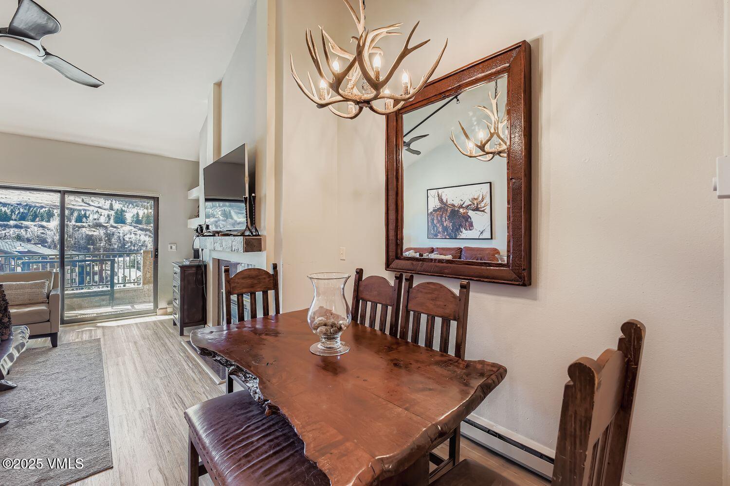 137 Benchmark Road, Unit 520 Avon, CO 81620 - Photo 6 of 26 a view of a dining room with furniture window and wooden floor