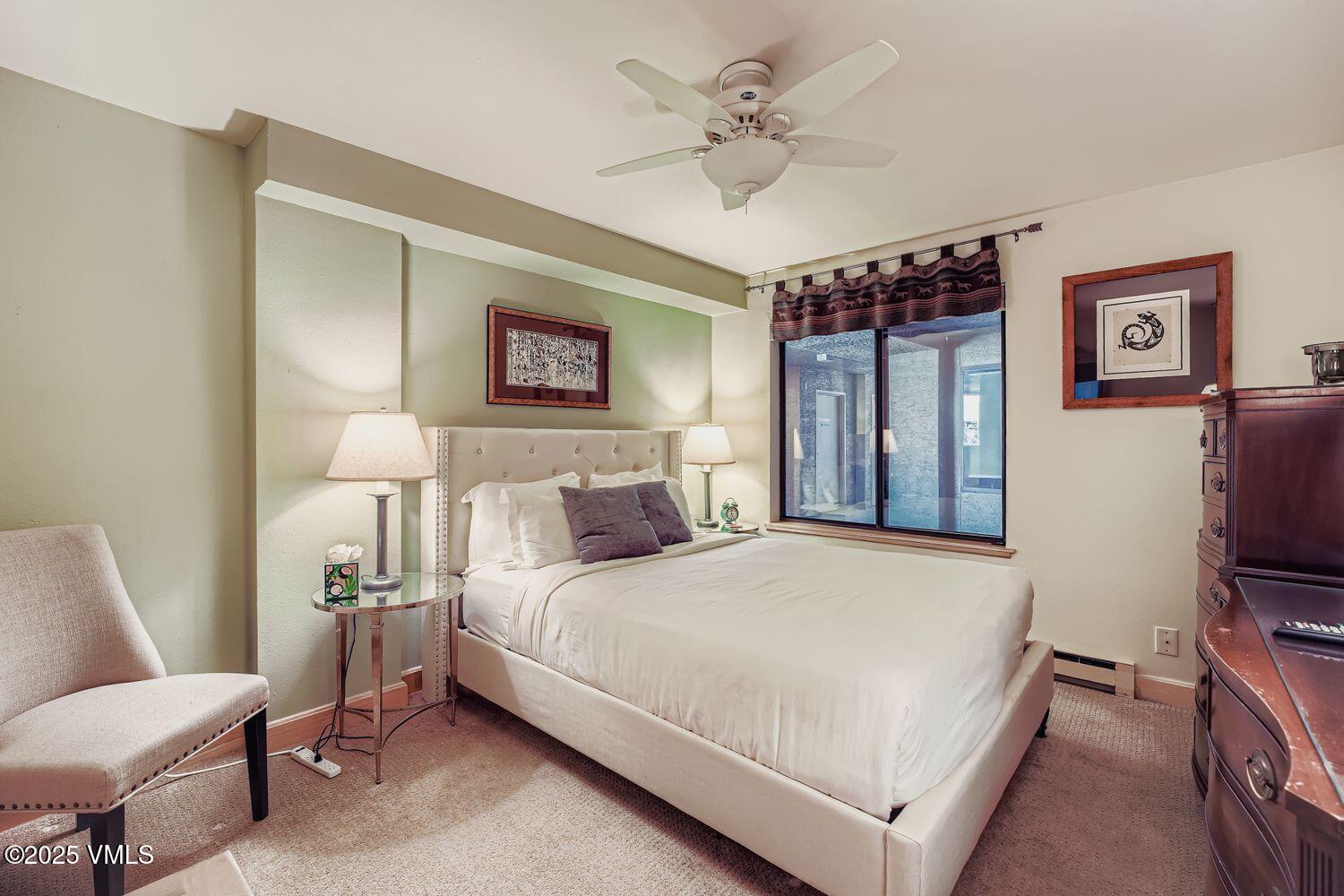 137 Benchmark Road, Unit 520 Avon, CO 81620 - Photo 8 of 26 a bedroom with a bed wooden floor and window