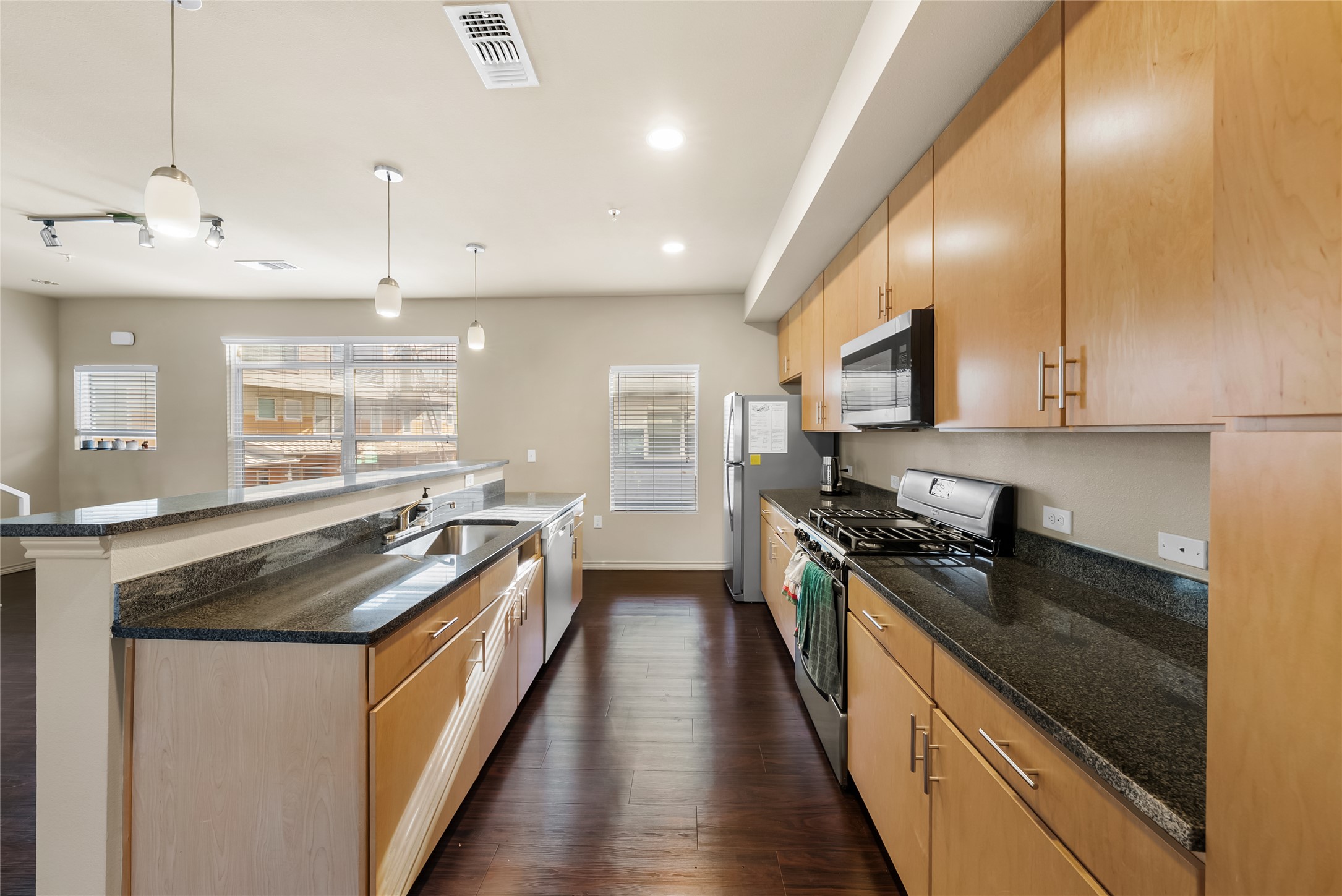 2606 Wilson Street, Unit 901 Austin, TX 78704 - Photo 11 of 37 a kitchen with granite countertop stainless steel appliances lots of counter top space