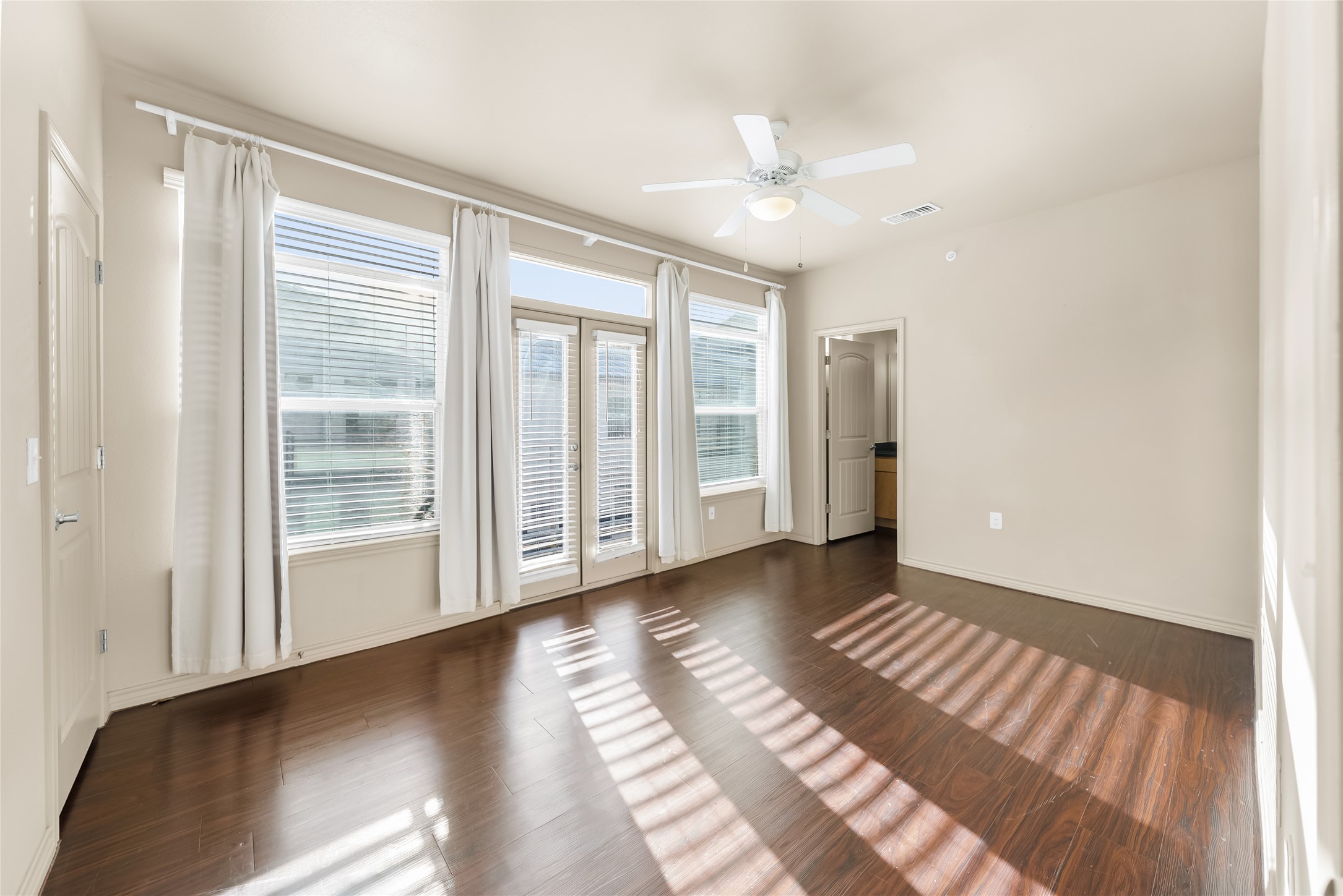 2606 Wilson Street, Unit 901 Austin, TX 78704 - Photo 21 of 37 a view of an empty room with wooden floor and a window