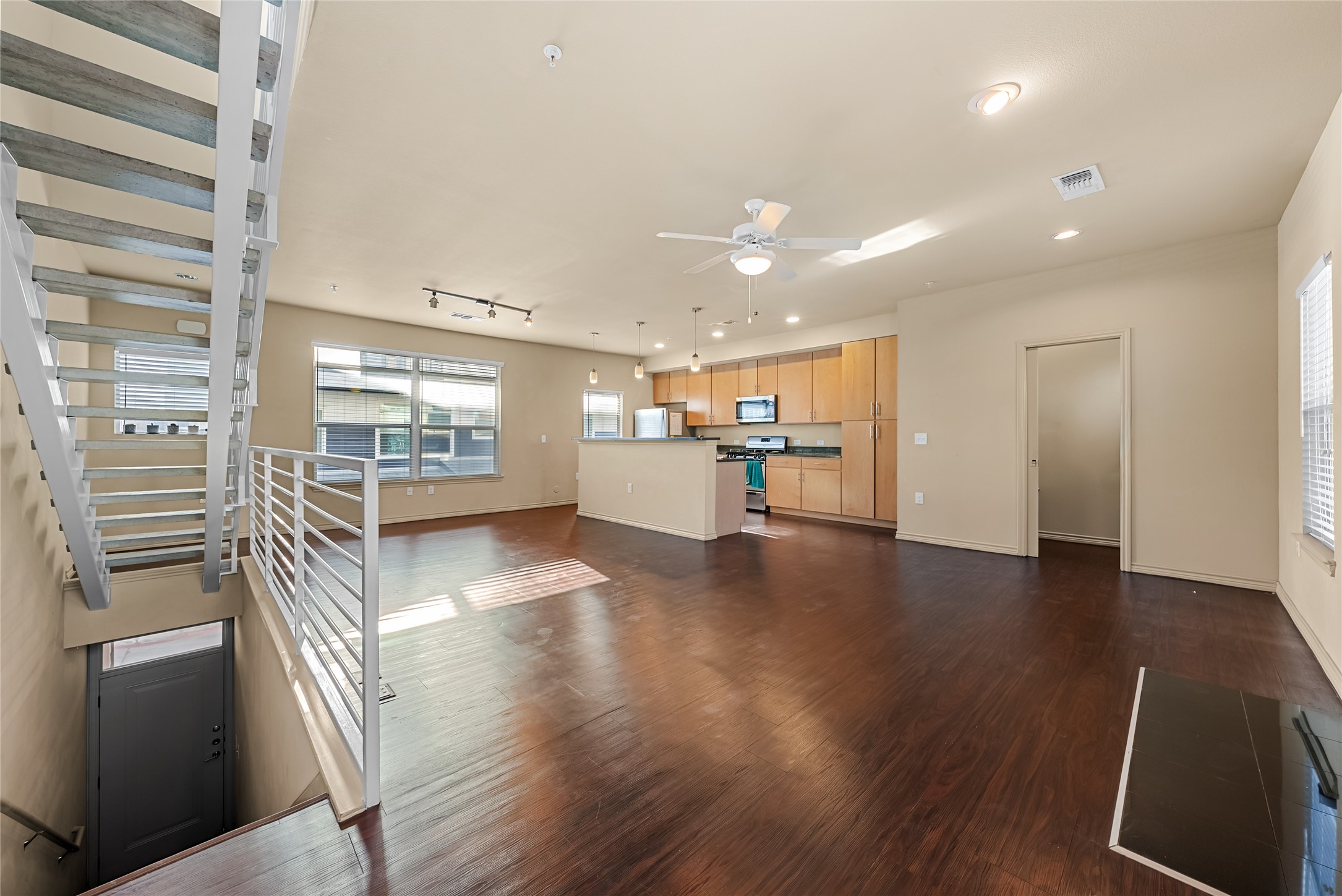 2606 Wilson Street, Unit 901 Austin, TX 78704 - Photo 5 of 37 a view of a kitchen with a sink and wooden floor