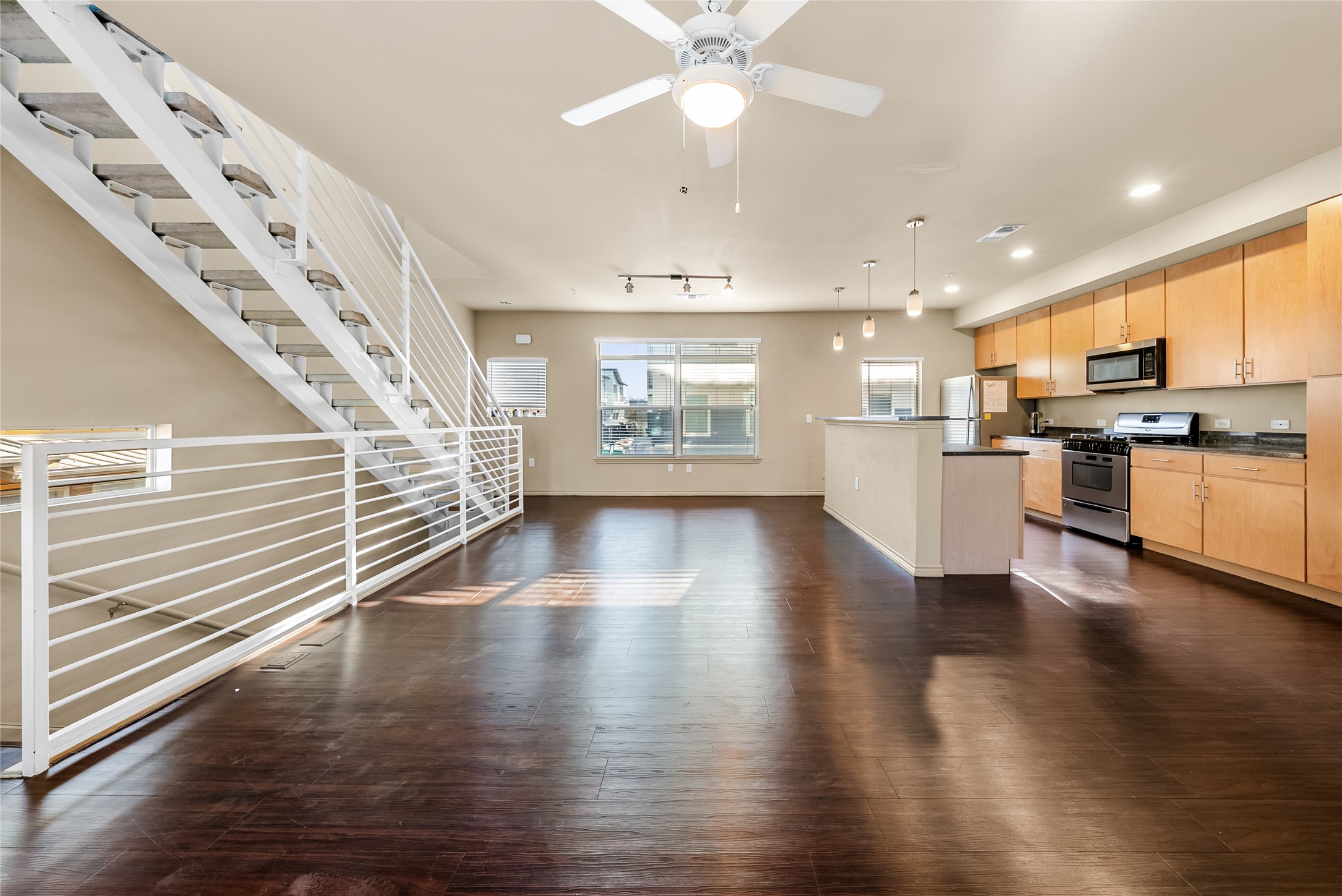 2606 Wilson Street, Unit 901 Austin, TX 78704 - Photo 7 of 37 a view of a kitchen with a stove wooden floor kitchen view and a window