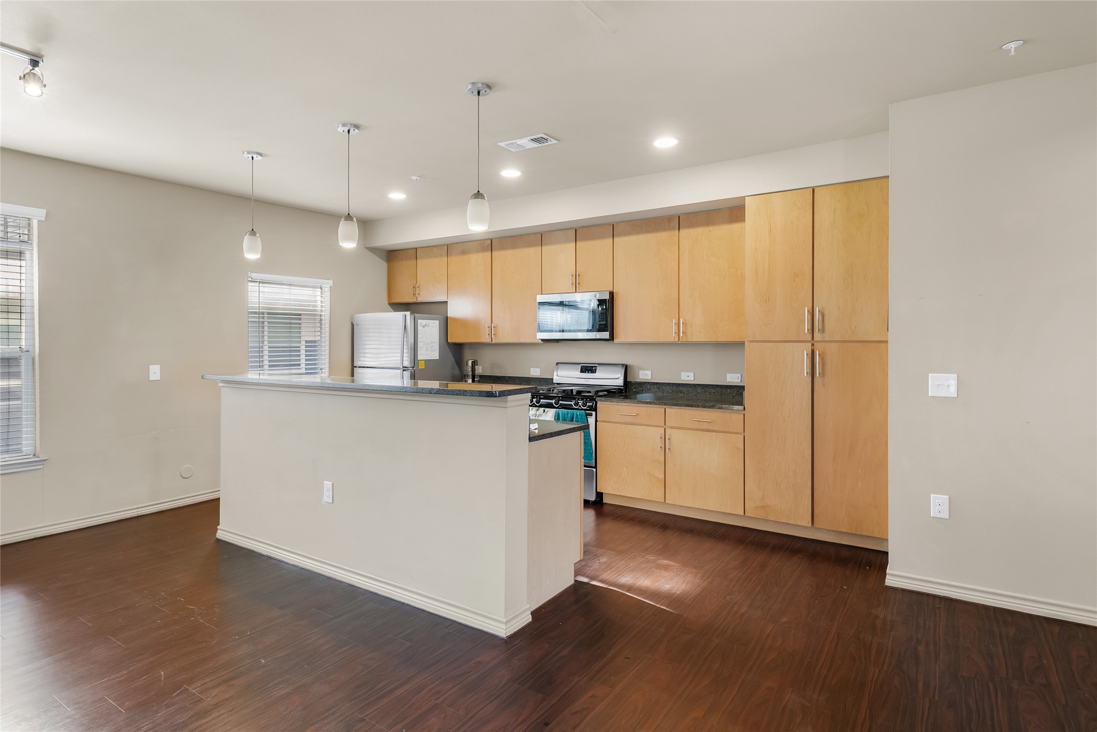 2606 Wilson Street, Unit 901 Austin, TX 78704 - Photo 10 of 37 a kitchen with stainless steel appliances granite countertop a stove a sink and a refrigerator