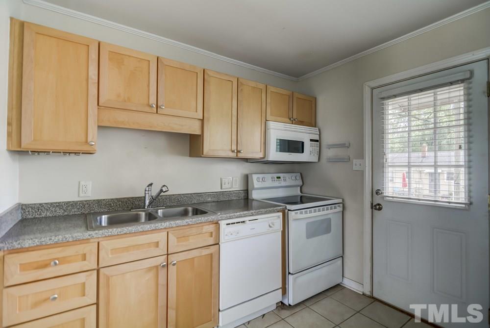 2325 Bernard Street, Unit 2325 Raleigh, NC 27608 - Photo 5 of 10 a kitchen with white cabinets and white appliances