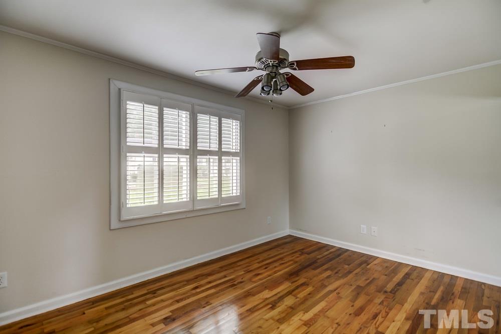 2325 Bernard Street, Unit 2325 Raleigh, NC 27608 - Photo 7 of 10 an empty room with wooden floor fan and windows