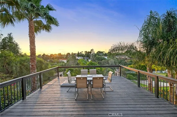 a view of a balcony with mountain view and wooden floor