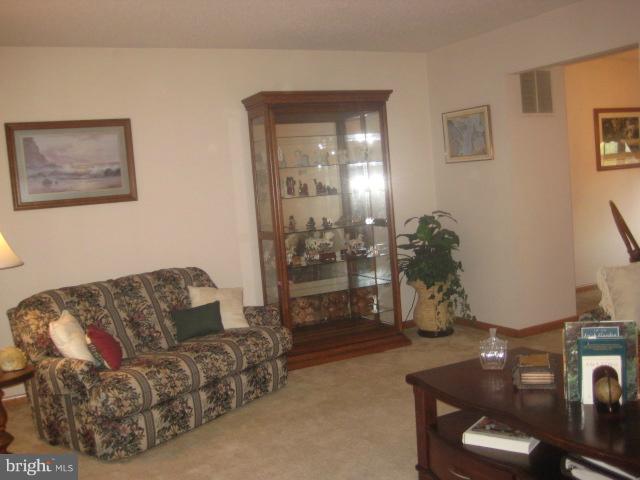 705 Sycamore Leaf Road Severn, MD 21144 - Photo 11 of 18 a living room with furniture and wooden floor