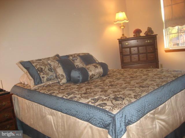 705 Sycamore Leaf Road Severn, MD 21144 - Photo 12 of 18 a bedroom with a bed and a window