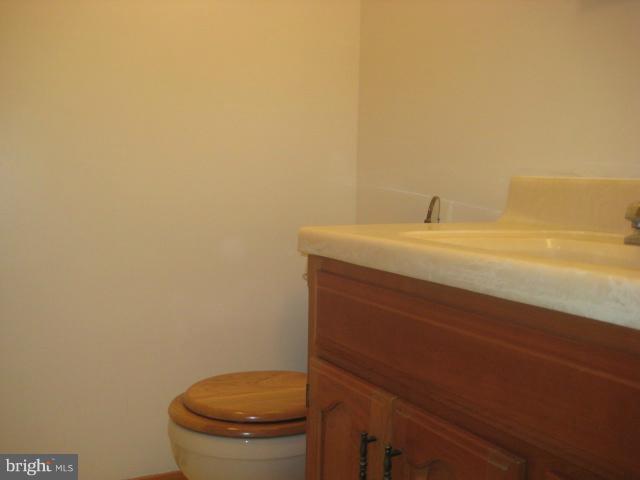 705 Sycamore Leaf Road Severn, MD 21144 - Photo 14 of 18 a bathroom with a granite countertop toilet and a sink
