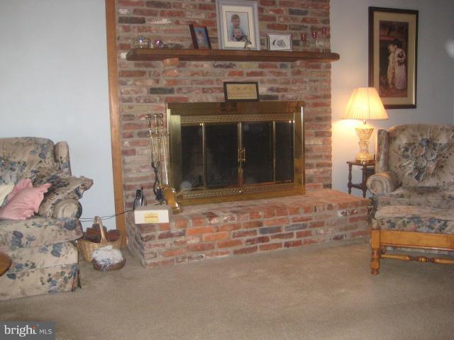 705 Sycamore Leaf Road Severn, MD 21144 - Photo 5 of 18 a view of a livingroom with furniture and a fireplace