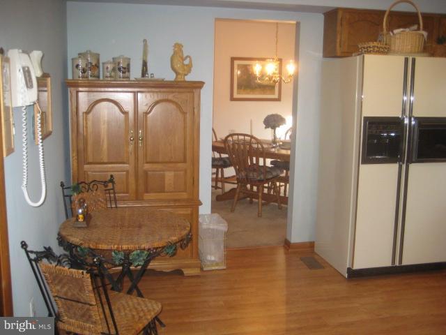 705 Sycamore Leaf Road Severn, MD 21144 - Photo 9 of 18 a dining room with furniture and wooden floor