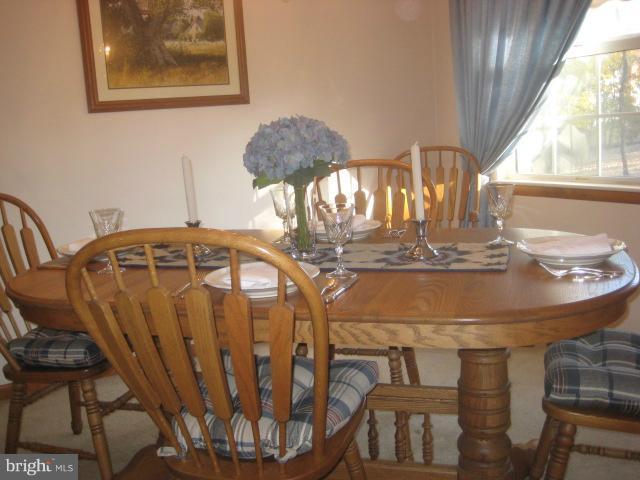 705 Sycamore Leaf Road Severn, MD 21144 - Photo 10 of 18 a view of a dining room with furniture and window
