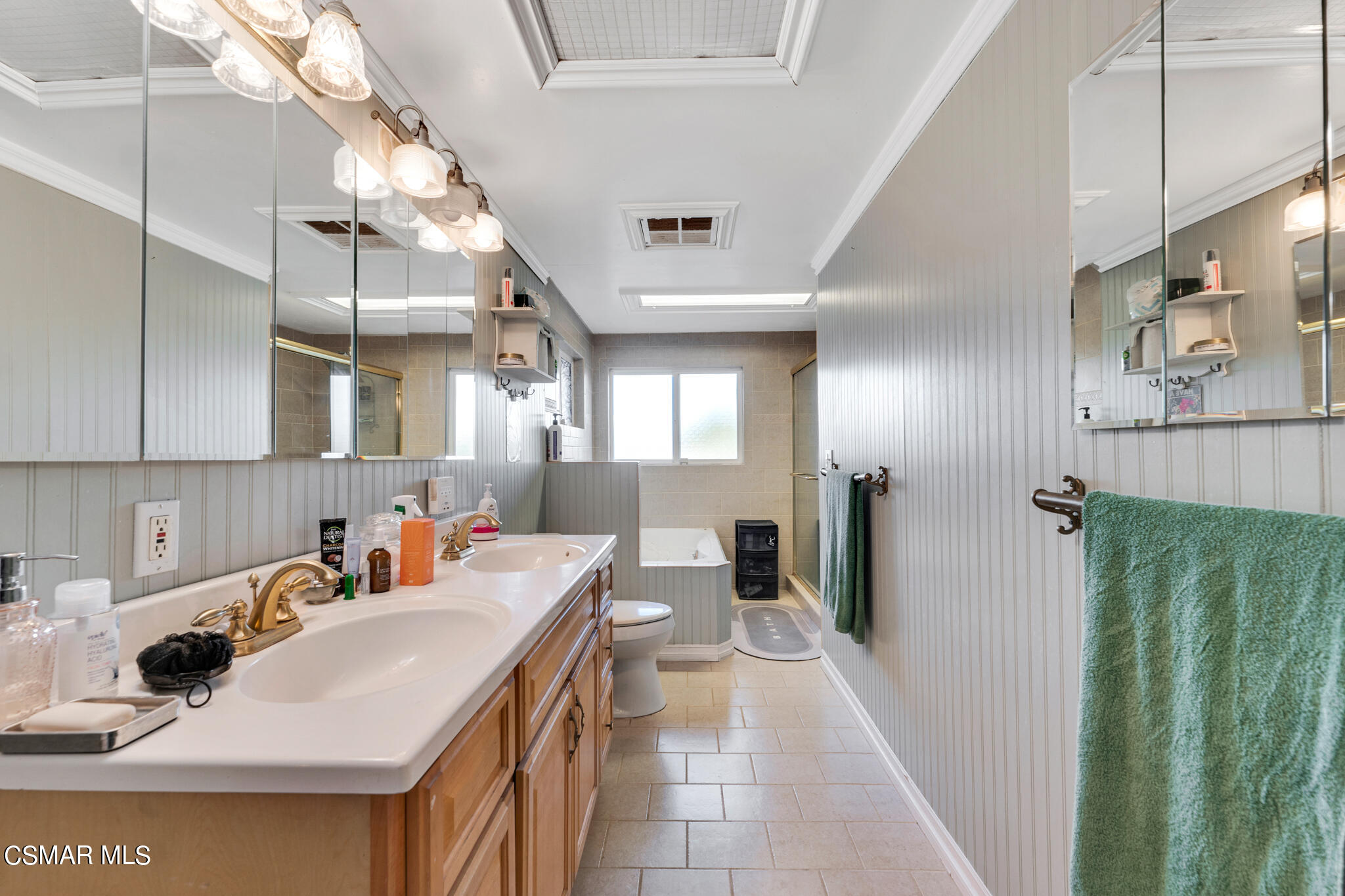 10767 Citrus Drive Moorpark, CA 93021 - Photo 35 of 65 a kitchen with stainless steel appliances a sink dishwasher a refrigerator and a dining table with the view of bathroom