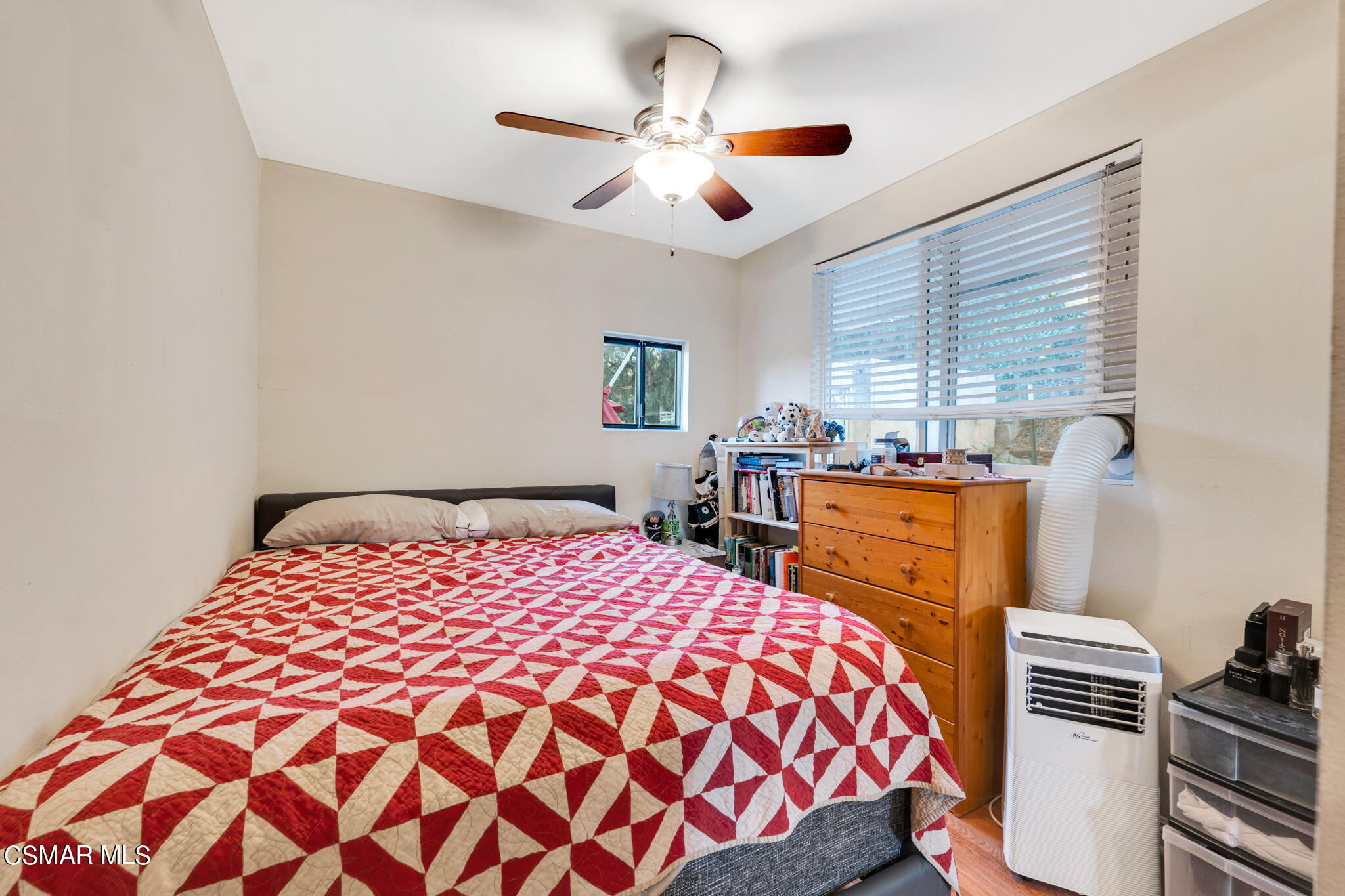 10767 Citrus Drive Moorpark, CA 93021 - Photo 51 of 65 a bedroom with a bed and a chandelier