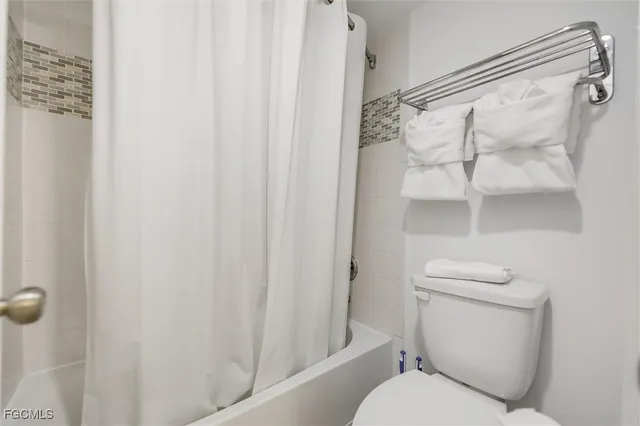 a bedroom with a bed and a lamp