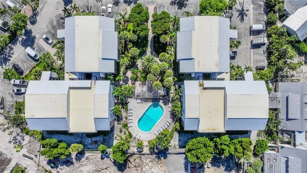an aerial view of a house with a yard and outdoor seating