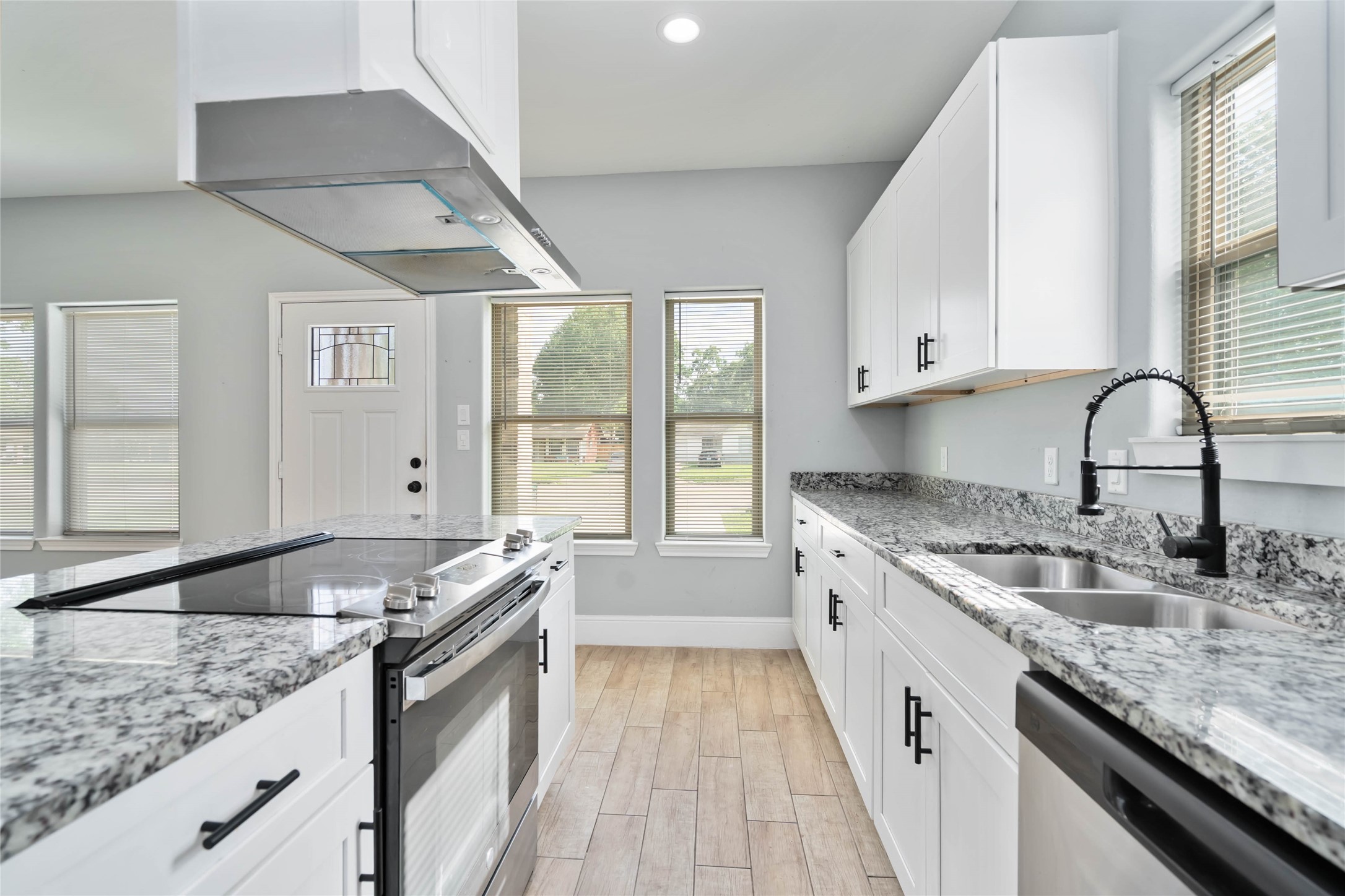 5754 Reed Road, Unit B Houston, TX 77033 - Photo 12 of 29 a kitchen with granite countertop a sink and a stove