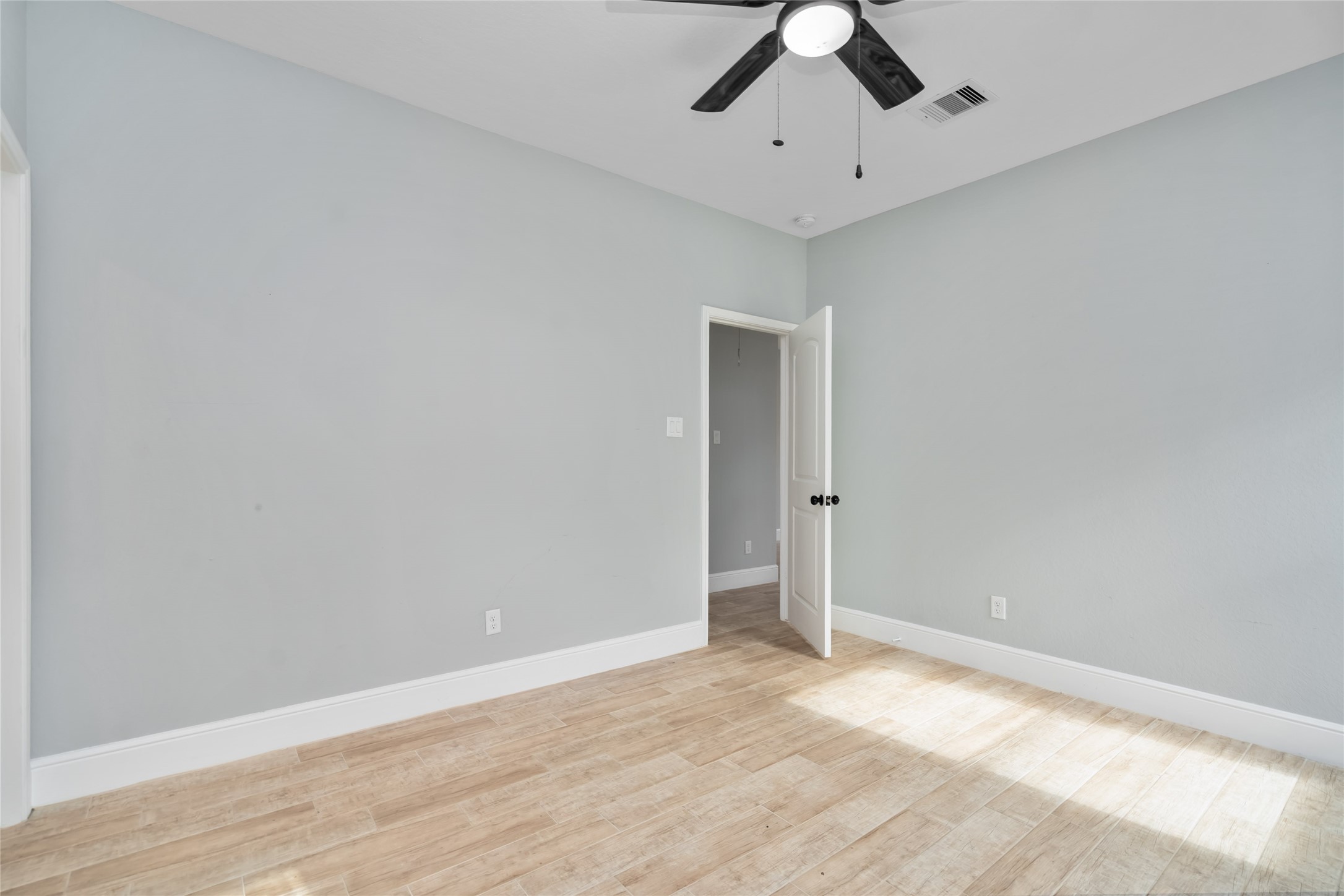 5754 Reed Road, Unit B Houston, TX 77033 - Photo 16 of 29 wooden floor in an empty room