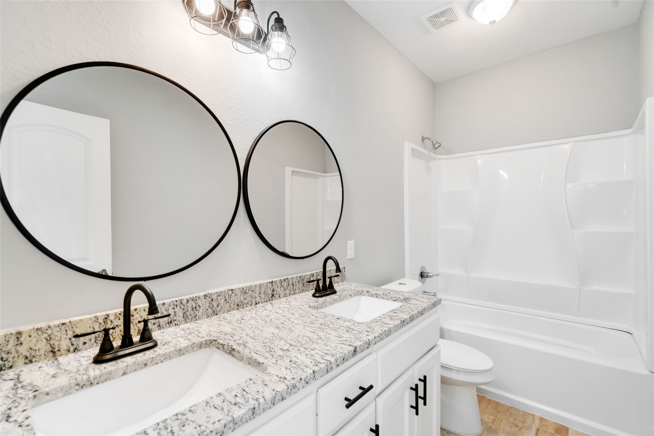 5754 Reed Road, Unit B Houston, TX 77033 - Photo 18 of 29 a bathroom with a granite countertop sink mirror and vanity