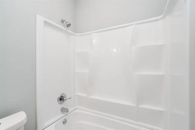 a bathroom with a shower and a bath tub