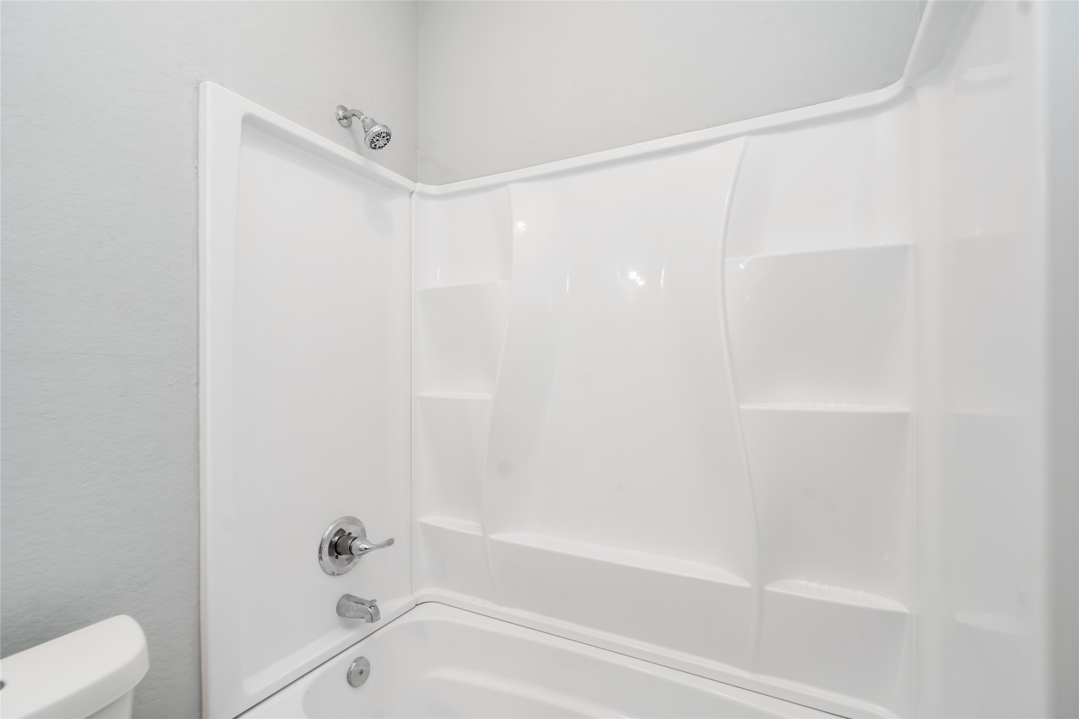 5754 Reed Road, Unit B Houston, TX 77033 - Photo 19 of 29 a bathroom with a shower and a bath tub
