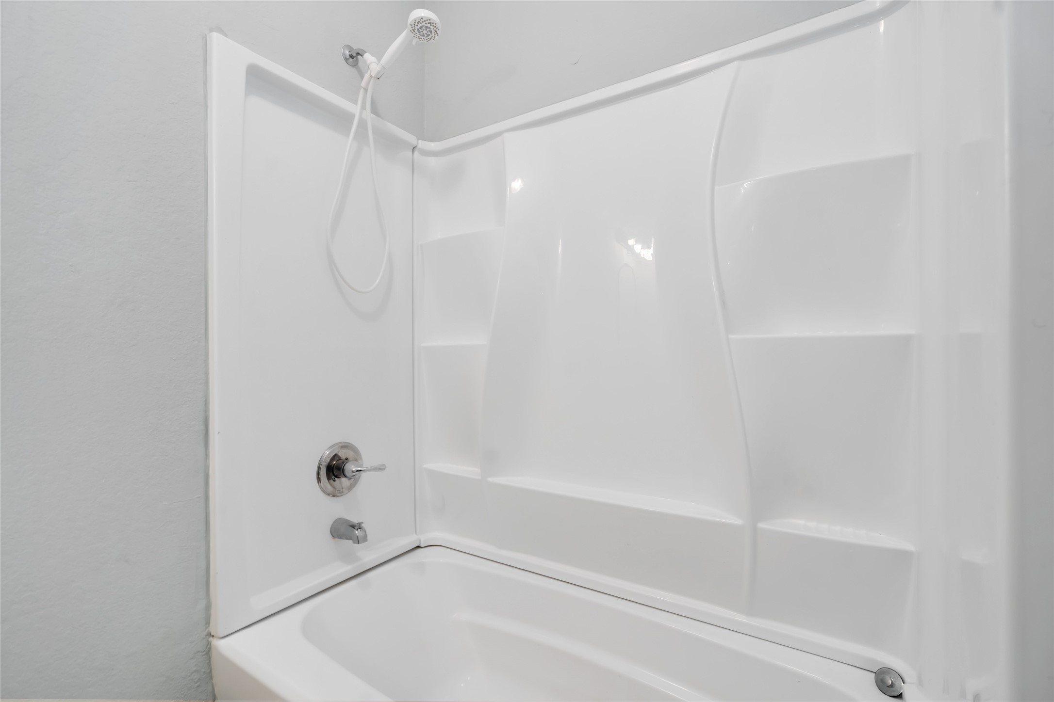 5754 Reed Road, Unit B Houston, TX 77033 - Photo 21 of 29 a bathroom with a bathtub and a shower