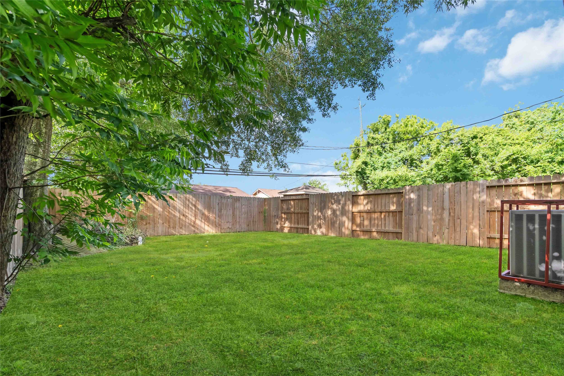 5754 Reed Road, Unit B Houston, TX 77033 - Photo 26 of 29 a view of a yard with plants and a fence