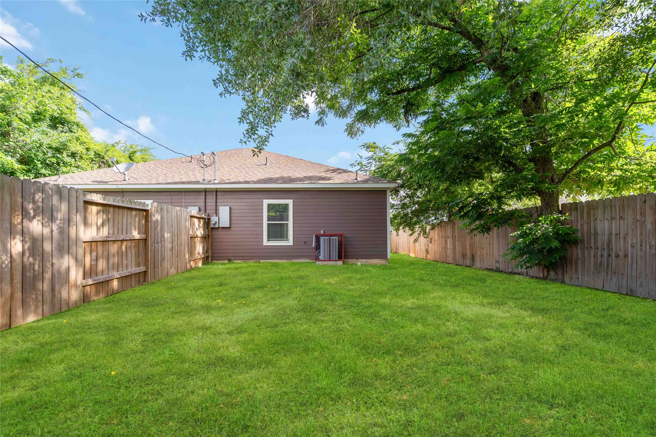 5754 Reed Road, Unit B Houston, TX 77033 - Photo 27 of 29 a front view of a house with a garden and yard