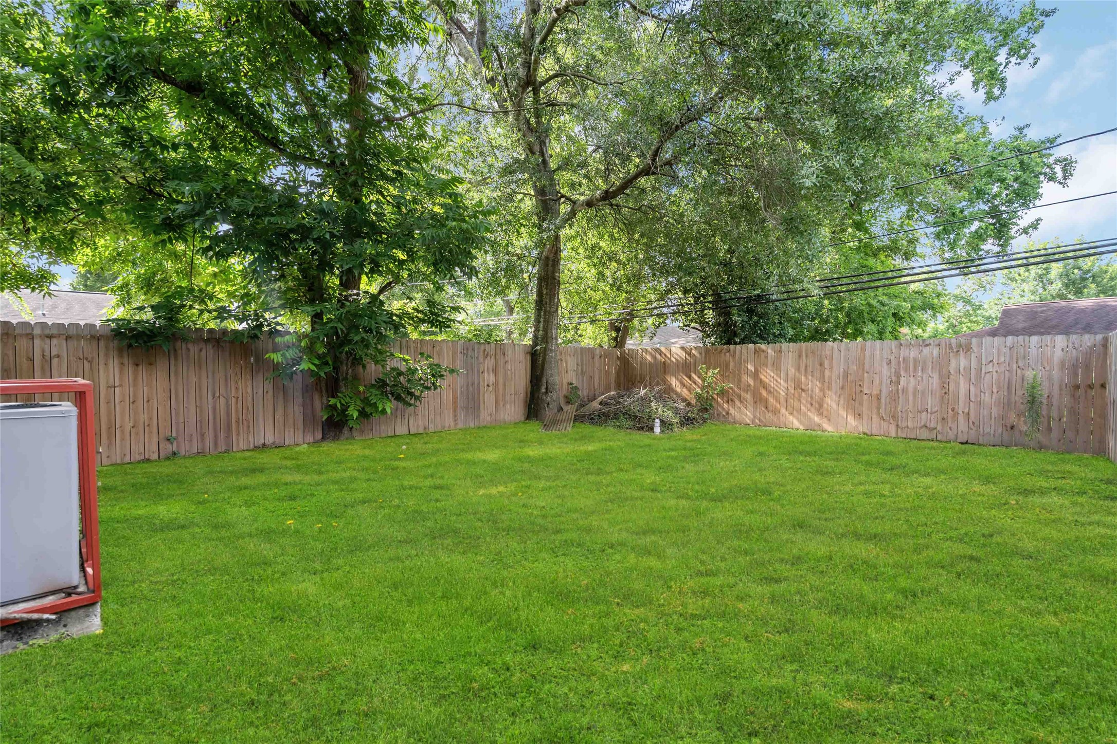 5754 Reed Road, Unit B Houston, TX 77033 - Photo 29 of 29 a view of a backyard with large trees and wooden fence