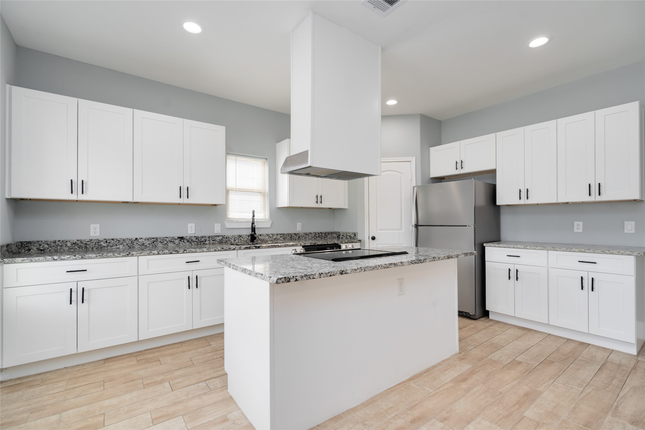 5754 Reed Road, Unit B Houston, TX 77033 - Photo 6 of 29 a kitchen with stainless steel appliances granite countertop a stove a sink and a refrigerator