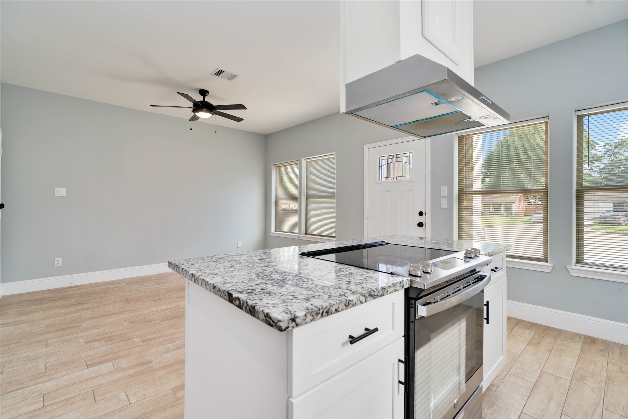 5754 Reed Road, Unit B Houston, TX 77033 - Photo 9 of 29 a kitchen with granite countertop a sink appliances cabinets and a large window