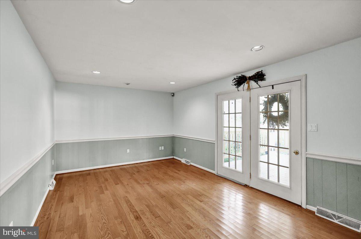 561 Millcross Road Lancaster, PA 17601 - Photo 17 of 52 an empty room with wooden floor and windows