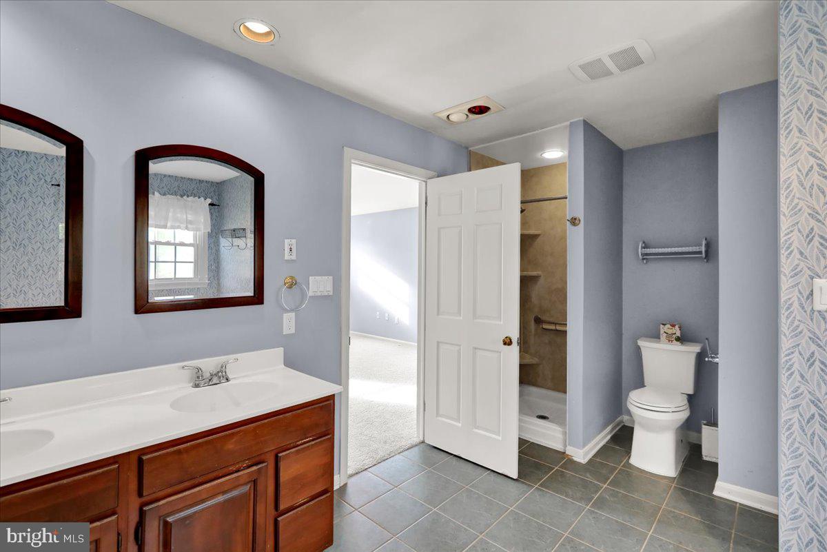561 Millcross Road Lancaster, PA 17601 - Photo 23 of 52 a bathroom with a double vanity sink mirror and toilet
