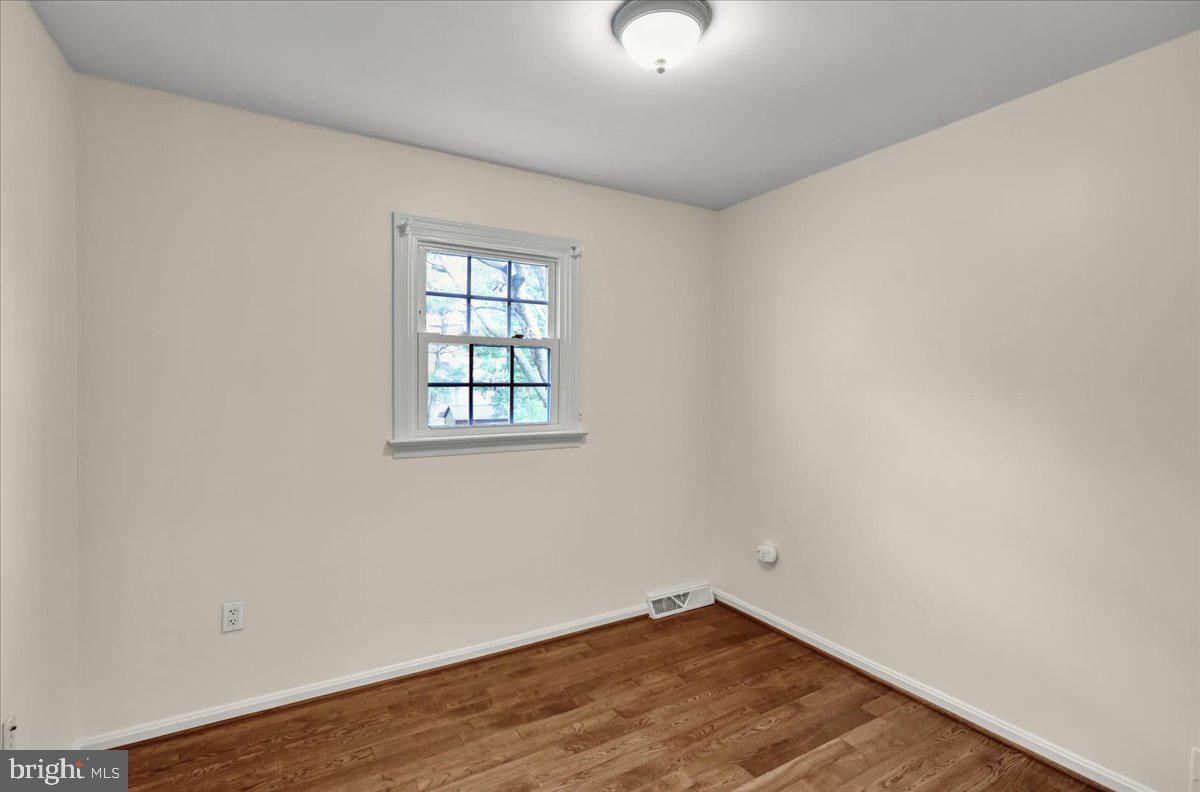 561 Millcross Road Lancaster, PA 17601 - Photo 29 of 52 an empty room with wooden floor cabinet and windows