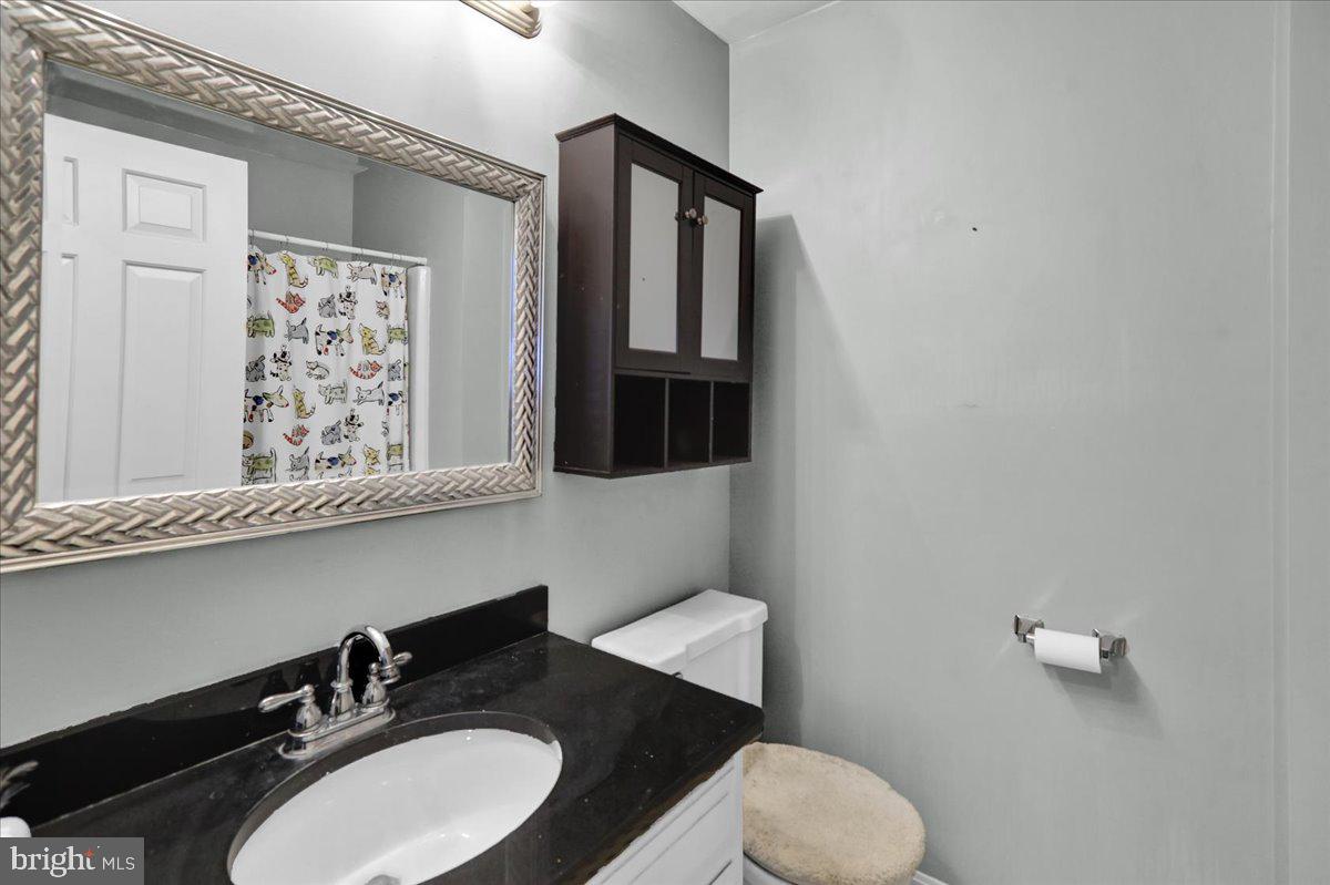 561 Millcross Road Lancaster, PA 17601 - Photo 33 of 52 a bathroom with a granite countertop toilet sink and mirror