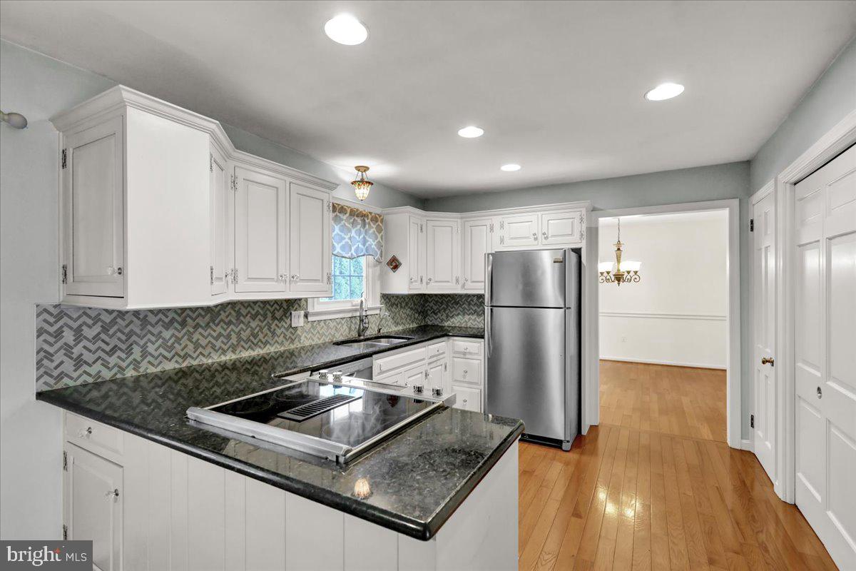 561 Millcross Road Lancaster, PA 17601 - Photo 9 of 52 a kitchen with stainless steel appliances granite countertop a refrigerator a sink a stove and white cabinets